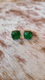 Round glitter studs set in gold in emerald green