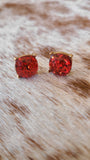 Round glitter studs set in gold in ruby red